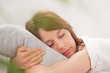 Portrait of a young woman sleeping on the bed