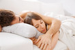 Portrait of a young couple sleeping on bed