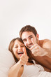 Happy couple smiling holding thumb up