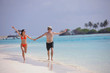 happy young couple have fun on beach