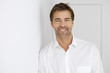 Smiling Man Wearing A White Shirt