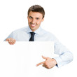 Photo: Businessman showing blank signboard, isolated Businessman showing blank signboard, isolated