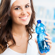 Photo: Woman with bottle of water, at fitness club Woman with bottle of water, at fitness club