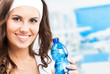 Photo: Woman with bottle of water, at fitness club Woman with bottle of water, at fitness club