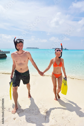 Photo: happy young couple have fun on beach happy young couple have fun on beach