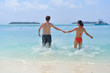 happy young couple have fun on beach