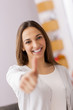Happy female smiling with her thumbs up