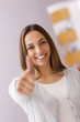 Happy female smiling with her thumbs up