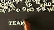 A person spelling Teamwork