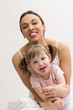 Mother and her daughter having fun and showing tongue