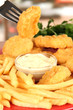 Fried chicken nuggets with french fries and sauce