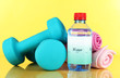 Dumbbells on yellow background