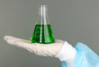 Glass tube with fluid in scientist hand during medical test