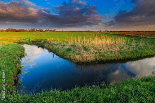 Photo: Grassland and ditch at sunset Grassland and ditch at sunset