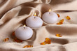 Candles on golden fabric close-up