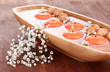 Beautiful candles in water on wooden table close-up