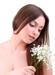 Beautiful young woman with flowers isolated on white
