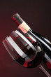 Wine in glass and wine bottle close-up on dark background