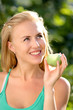 Portrait of young beautiful happy smiling woman with green apple