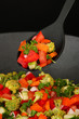 Vegetable ragout in wok, isolated on black