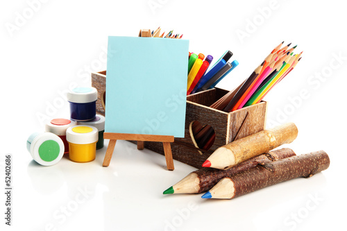 Photo: Different pencils in wooden crate, paints and easel, isolated Different pencils in wooden crate, paints and easel, isolated