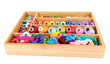 Photo: Colorful threads for needlework in wooden box isolated on white Colorful threads for needlework in wooden box isolated on white