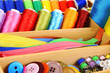Colorful threads for needlework in wooden box close up