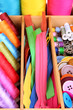 Colorful threads for needlework in wooden box close up