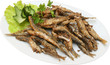 fried sprats with lettuce on plate isolated