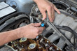 Mechanic fixing fuel injector, two camshaft car engine