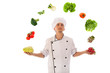 Cook juggling with fresh vegetables