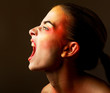 Photo: Scared young woman gesturing on black background Scared young woman gesturing on black background