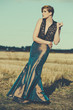 fashion model posing outdoor in a rural setting