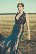 fashion model posing outdoor in a rural setting
