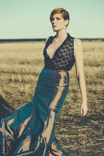 Photo: fashion model posing outdoor in a rural setting fashion model posing outdoor in a rural setting