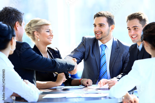 Photo: Two business colleagues shaking hands during meeting Two business colleagues shaking hands during meeting