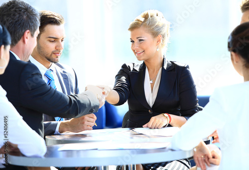Photo: Happy business man and woman shaking hands Happy business man and woman shaking hands