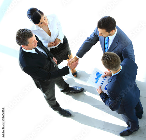 Photo: Top view of a successful business deal at office Top view of a successful business deal at office