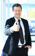 Foto: Businessman showing OK sign with his thumb up. Businessman showing OK sign with his thumb up.