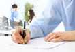 Foto: Hands writing on a paper Hands writing on a paper