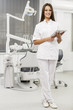 Young dentist with tablet