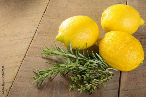 Photo: Lemons and herbs on a wooden table Lemons and herbs on a wooden table