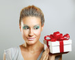 Girl opening x-mass present isolated on grey background