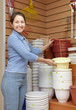 woman chooses plastic flower pot