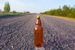 bottle on an asphalt road