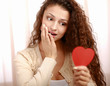 Beautiful smiling caucasian woman with heart symbol