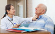 Doctor touching  neck of  senior man