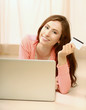 Photo: Woman with laptop lying down on the floor Woman with laptop lying down on the floor