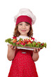 happy little girl cook with stuffed chicken meat and salad