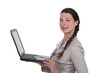 Photo: young woman standing with laptop young woman standing with laptop